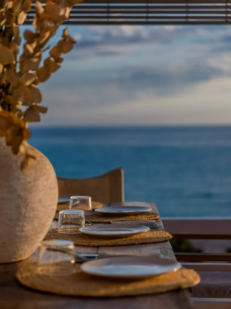 Wooden table place settings at dusk